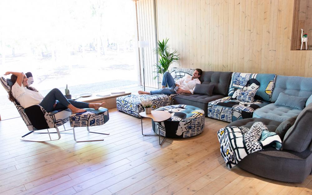 two people relaxing on corner sofa